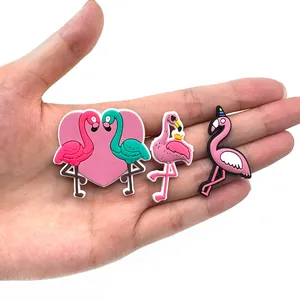 Set of three colorful PVC flamingo shoe charms for clogs featuring cute cartoon designs