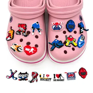 Ice hockey themed PVC shoe charms set featuring players and gear on pink clogs