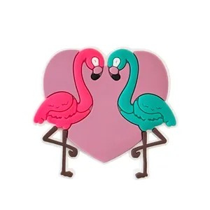 Detailed view of heart-shaped flamingo shoe charm made of soft PVC for garden clogs