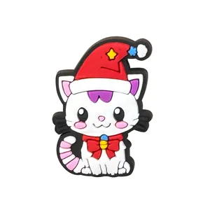 Detail shot of a cute 3D Christmas cat PVC shoe charm with red hat and bell for clogs