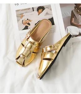 Top view of gold woven closed-toe mules with metallic finish and buckled strap