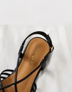 Detail of soft breathable lining and golden logo on woven strap beach sandals