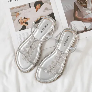 Elegant silver flat sandals with rhinestone butterflies and adjustable ankle straps
