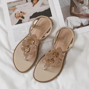 Flat gladiator beach sandals with sequin flowers and elastic heel strap for women
