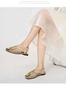 Detail of gold metallic braided flat sandals with ankle strap buckle and soft sole