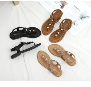 Detail view of bohemian flat sandals with beaded flower straps in three distinct colors