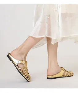 Side view of golden metallic woven mule sandals with cutout straps and buckles