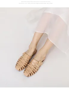 Macro detail of beige woven leather sandals featuring an elegant gold metal buckle accent