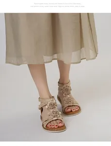 Detail of champagne gold flat sandals with 3D flower decor and cork style soles