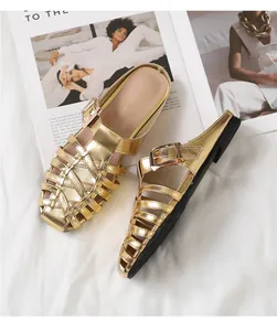 Detailed view of gold woven cage mule flat with rose gold buckle and logo insole