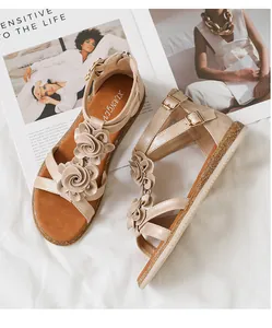 Detail of bohemian gold flower sandals with ankle straps and non-slip platform sole