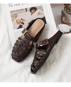 Detailed close-up of woven dark brown leather mule with a large gold metal buckle