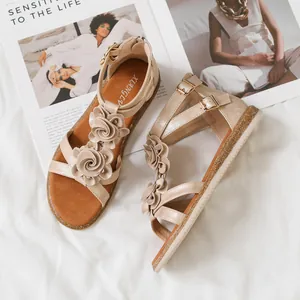 Champagne gold flat bohemian sandals with floral decoration and ankle zipper closure