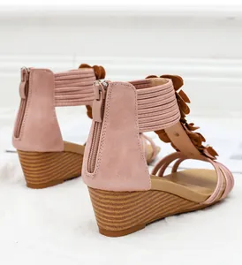 Detailed back view of pink floral wedge sandals with zipper and wood grain sole