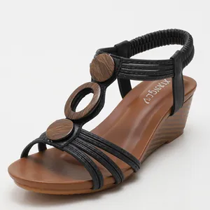 Women's bohemian wedge sandals with black straps, wooden rings and a wood grain platform
