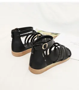Detail view of black bohemian gladiator sandals with woven straps and rear zipper closure