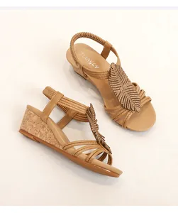 Close-up of beige wedge sandals featuring cork heel and sparkling leaf-shaped rhinestones