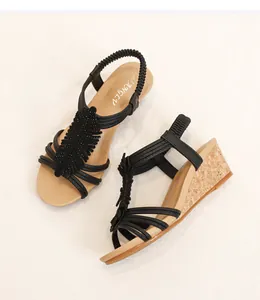 Detail of wedge sandals featuring crisscross straps and natural cork texture sole