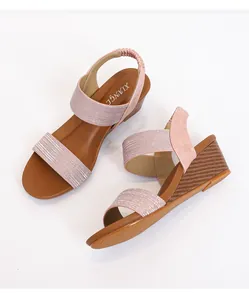 Pink wedge sandals with glitter straps and textured brown wood-style heels for women