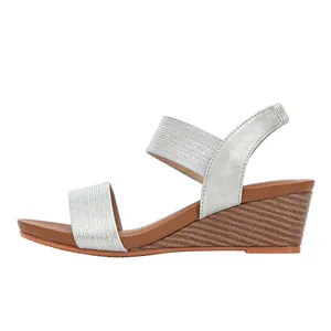 Detail view of silver elastic straps and cork texture wedge sole for women's sandals