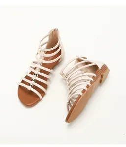 Detail of wedge sandals showing back zipper closure and non-slip diamond pattern sole