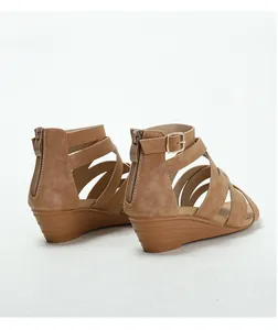 Detail of tan wedge sandals with multi-strap suede upper and rear zipper closure