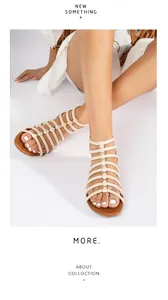 Detail of cream Roman flat sandals featuring golden pyramid studs on multi-strap design