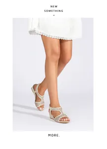 Detail of champagne wedge sandals featuring rhinestone cutouts and elastic heel strap