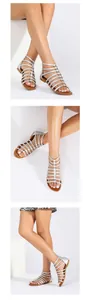 Detail view of silver gladiator sandals with metallic straps and flat brown soles