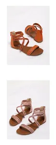 Detail van bohemian platte sandalen met kruisbandjes en rits in oranje en roze kleuren