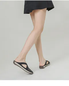 Close-up of women's black wedge mule shoes with sequin straps and comfortable rubber sole
