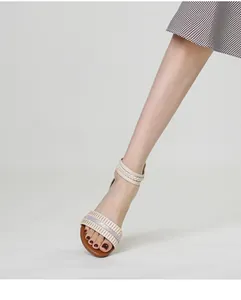 Detail of wedge sandals with rhinestones, pleated straps and braided ankle cord