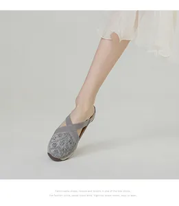 Detailed close-up of grey knitted walking shoes featuring glitter fabric and elastic straps