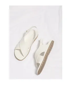 Detail of white cross-strap sandals with soft slingback and anti-slip rubber sole