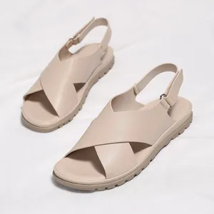 Beige cross-strap flat sandals for women with adjustable buckle and non-slip sole