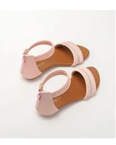 Detail of pink wedge sandals featuring rhinestone bands and a rear zipper closure