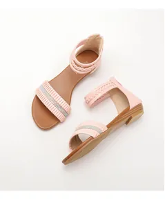 Macro shot of pink pleated strap with rhinestone inlay on children wedge sandals