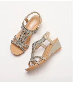 Detailed macro view of champagne gold wedge sandals featuring intricate rhinestone straps