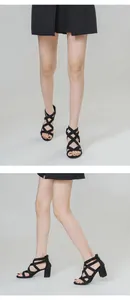 Detalle de sandalias negras de tacón ancho con tiras de strass y cremallera trasera