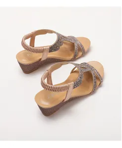 Detail of wedge sandals with champagne gold sequins and textured platform sole