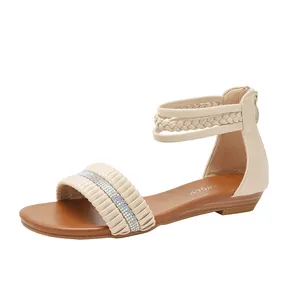 Women's beige wedge sandals with rhinestone strap and woven ankle detail on white background