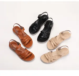 Overhead view of wedge sandals in black, brown and beige with woven straps and metal studs