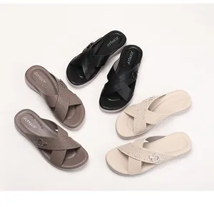 Detailed view of wedge sandals with laser-cut straps in black, brown and beige colors