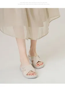 Detail of off-white platform wedge sandals with perforated straps and metal buckles