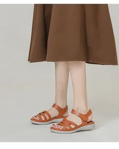 Brown wedge sandals with crisscross leather straps and adjustable velcro ankle fastener