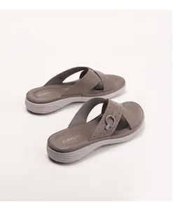 Macro shot of cross strap brown men sandals with breathable perforations and metal buckle