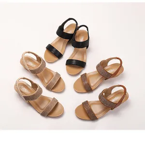 Detail of bohemian wedge sandals featuring rhinestone straps in black, beige and brown