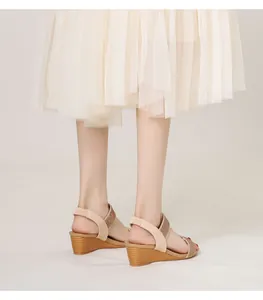Detail of bohemian wedge sandals with rhinestone straps and elastic heel support