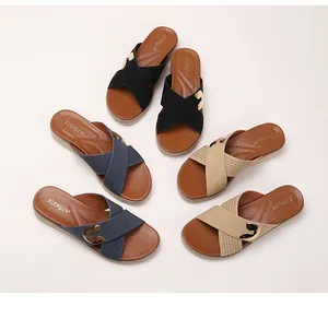 Flat bohemian sandals with crossed straps and metal buckle in black, blue and khaki