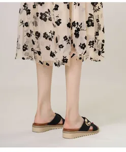 Detail of bohemian wedge flip-flops with golden metal buckles and anti-slip sole